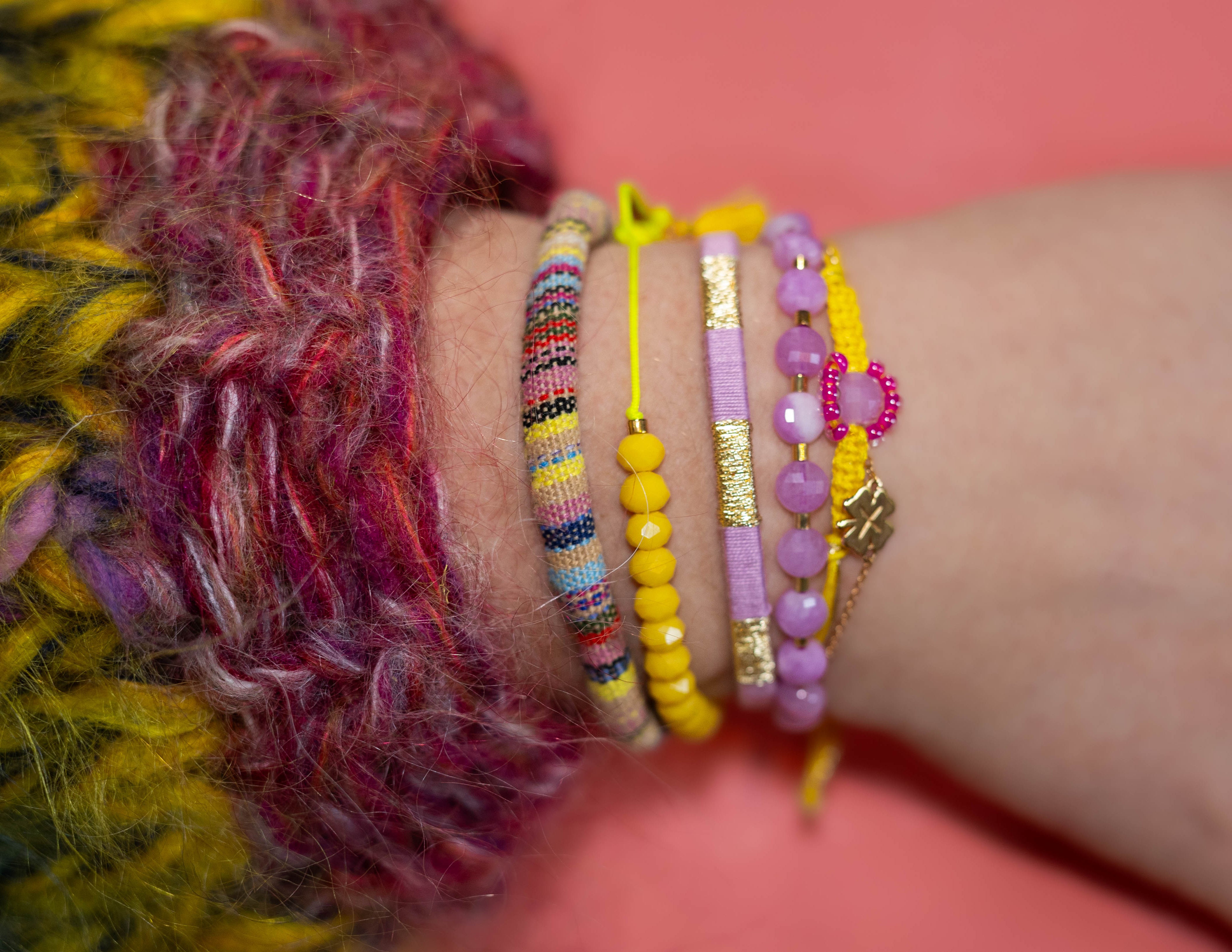 Arm met armbandenset van Bert Sieraden in geel en roze.